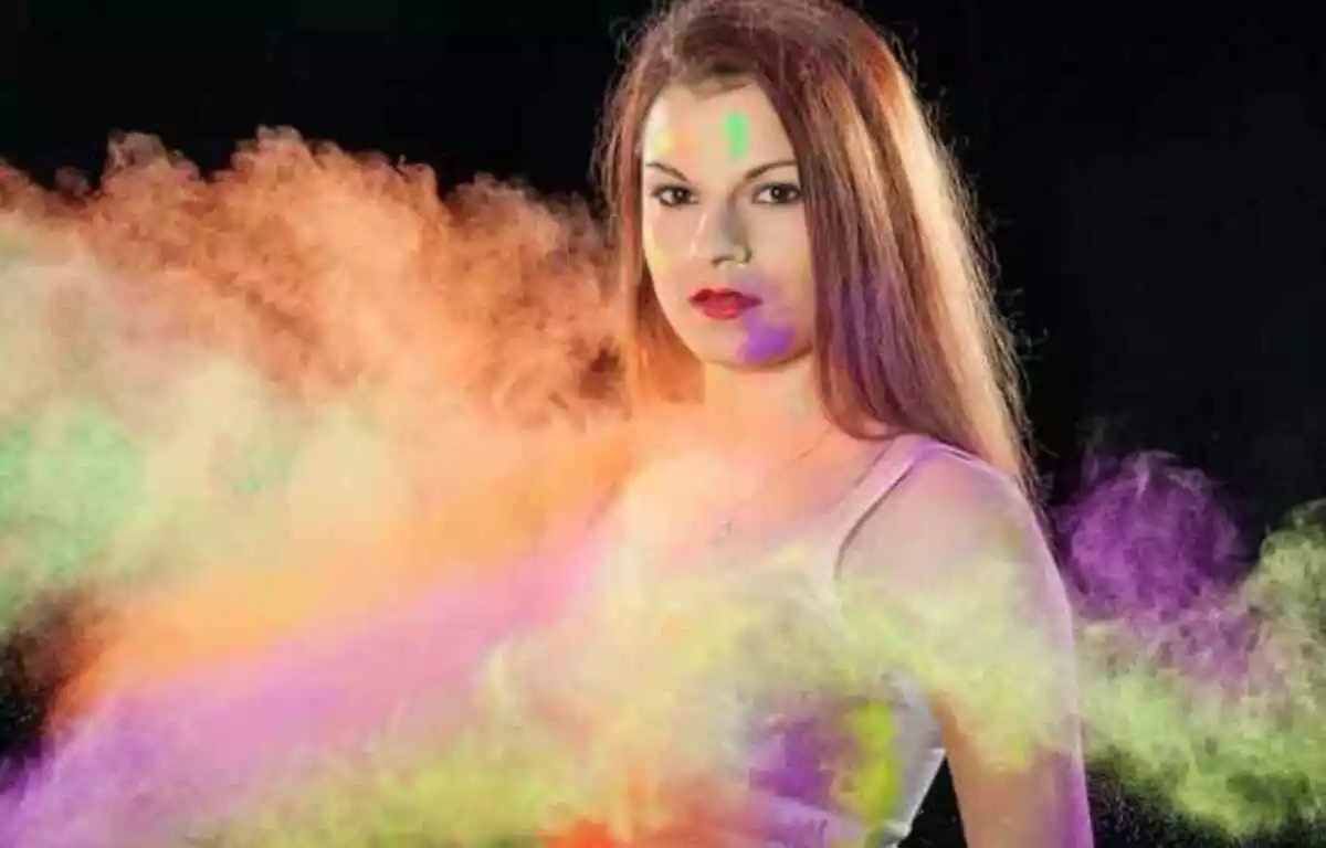 Mujer en carnaval con polvos de colores
