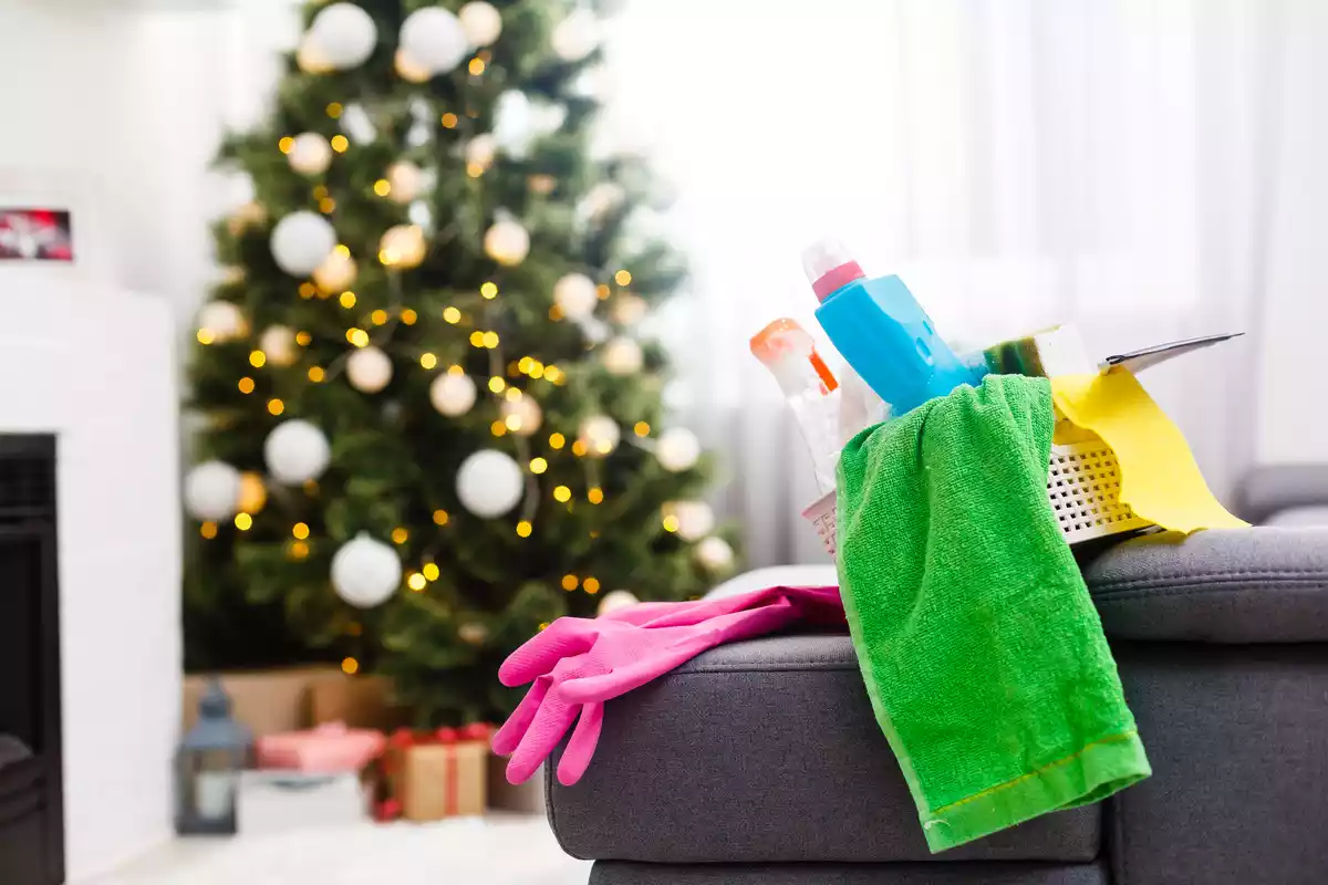 Productos de limpieza en un sofá con el árbol de navidad al fondo