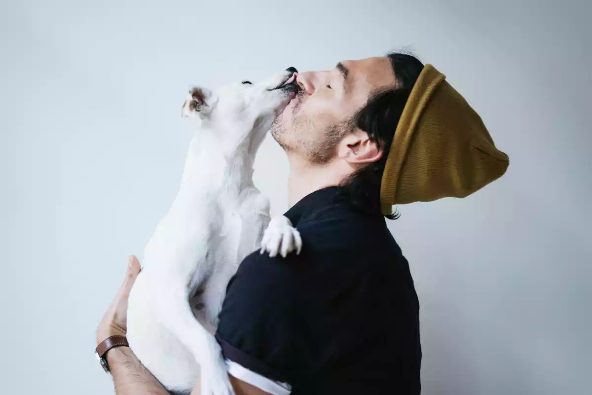 Un chico con gorro con un perro